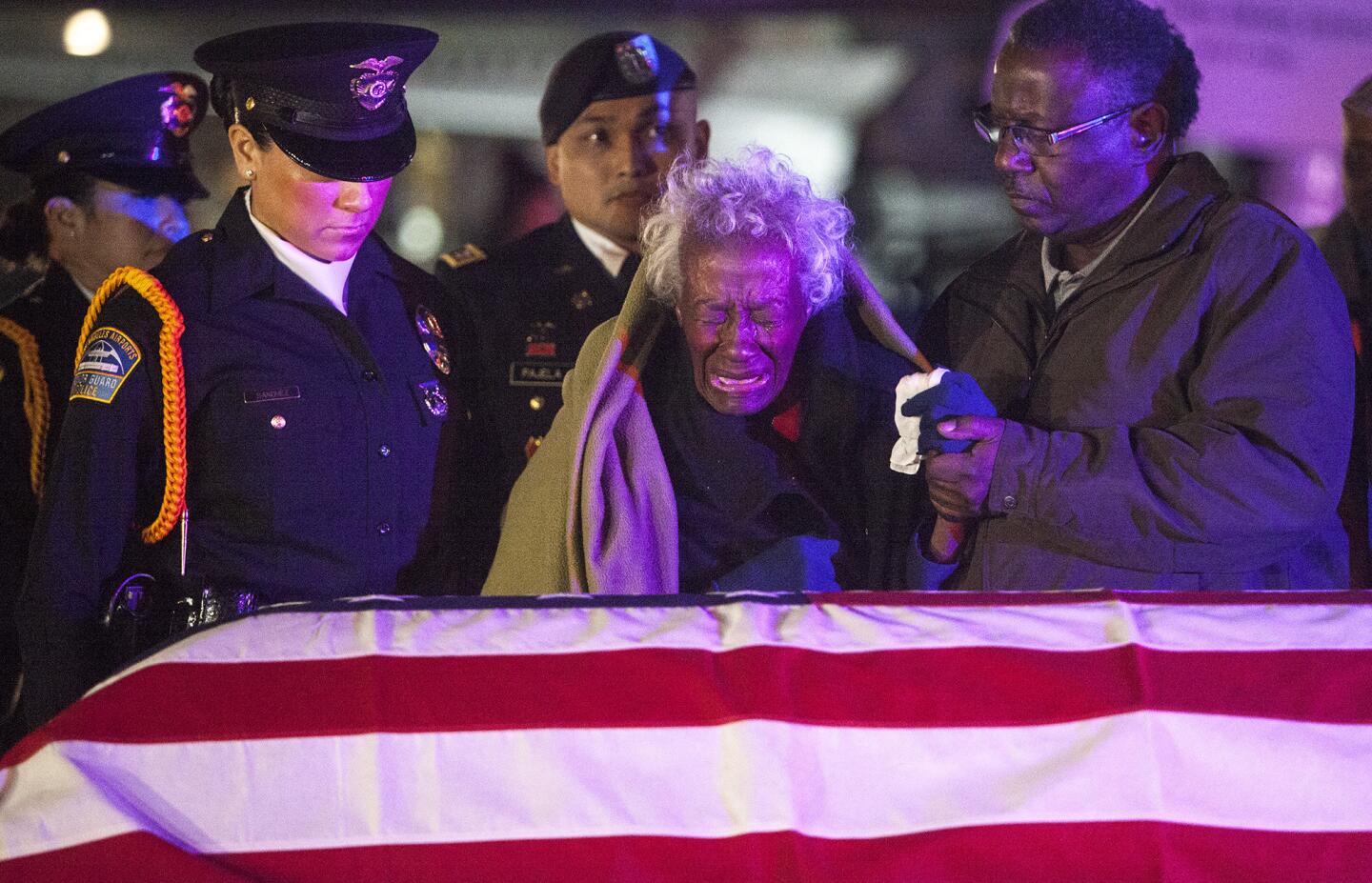 Clara Gantt, the 94-year-old widow of U.S. Army Sgt. Joseph Gantt, weeps in front of her husband's casket at Los Angeles International Airport.