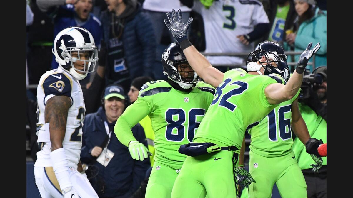 Seahawks tight end Luke Willson (82) celebrates a touchdown in front of Rams cornerback Trumaine Johnson during the second quarter of a game on Thursday.