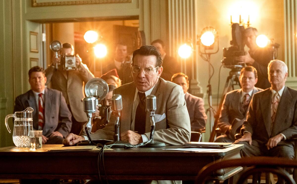 Dennis Quaid, as Ronald Reagan, testifying before Congress with photographers behind him