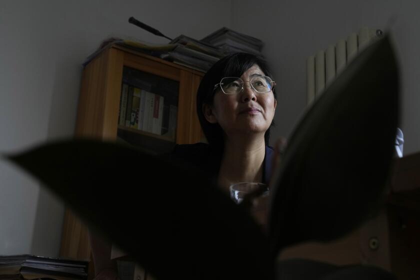 Activist Wang Yu, who found that her COVID-19 health app changed color and prevented her from traveling, speaks during an interview, Thursday, June 30, 2022, in Beijing. There was no evidence that she was sick or had been exposed to the virus. (AP Photo/Ng Han Guan)