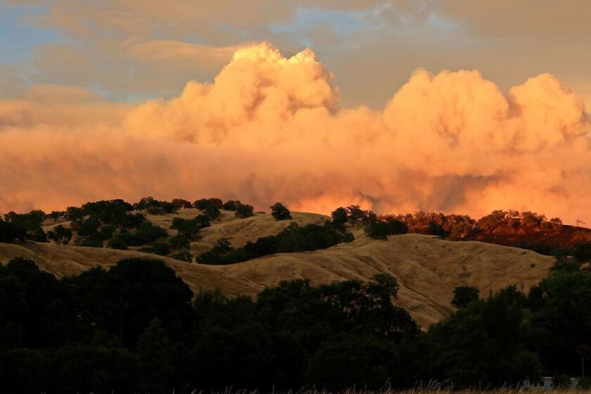 Mandatory Credit: Photo by ALAN SIMMONS/EPA-EFE/REX/Shutterstock (9774365a) Sunset strikes the smoke clouds from the Ranch Fire portion of the Mendocino Complex Fire near the Mendocino National Forest near Willows, California, USA, 29 July 2018 (issued 30 July 2018). The River and Ranch fires combined as the Mendocino Complex Fire with more than 56,000 acres (22,660 hectares) burned, nearly doubling since Sunday with more than 10,000 people already evacuated. Mendocino Complex Fire, Willows, USA - 29 Jul 2018 ** Usable by LA, CT and MoD ONLY **