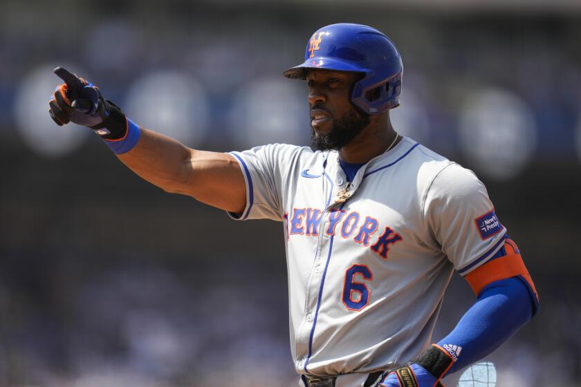 New York Mets' Starling Marte reacts after a single during the fourth inning of a baseball game against the Los Angeles Dodgers in Los Angeles, Saturday, April 20, 2024. Joey Wendle scored. (AP Photo/Ashley Landis)