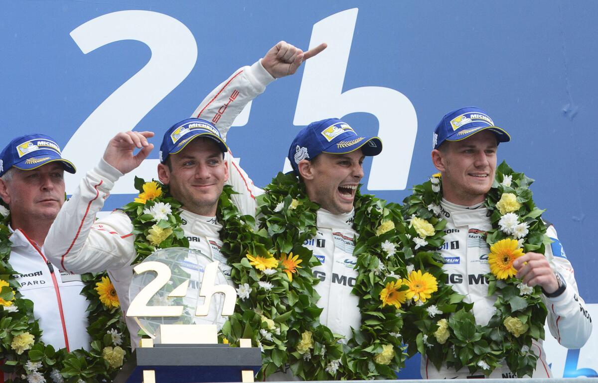 Britain's Nick Tandy, New Zealand's Earl Bamber and Germany's Nico Hulkenberg celebrate on the podium after winning the 24 Hours Le Mans endurance race.