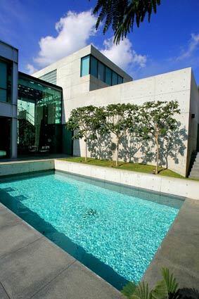 The Glendale home of Aida and Vahe Yeghiazarian looks like a concrete fortress from the front: blank, angular and windowless. But the design by Jerrold E. Lomax opens up dramatically in back, shown here, with an upstairs bedroom overlooking the pool and banks of glass connecting the inside to the outdoors. The Yeghiazarians worked to honor the architect's original concept without sacrificing their own personal tastes.