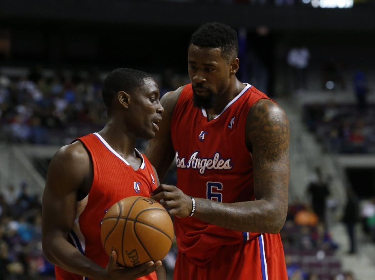 Clippers Darren Collison, left, and DeAndre Jordan chat during a game against the Detroit Pistons.