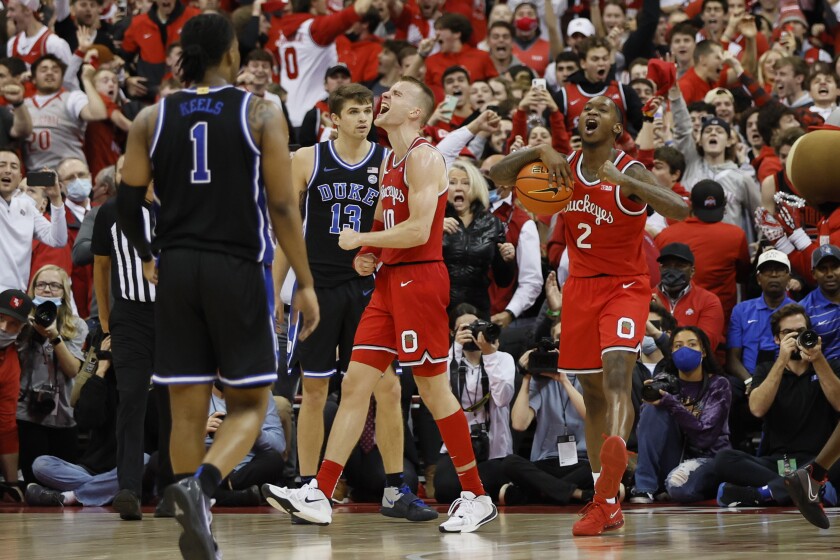Ohio State's Justin Ahrens, left, and Cedric Russell celebrate the team's win over Duke in an NCAA college basketball game Tuesday, Nov. 30, 2021, in Columbus, Ohio. (AP Photo/Jay LaPrete)