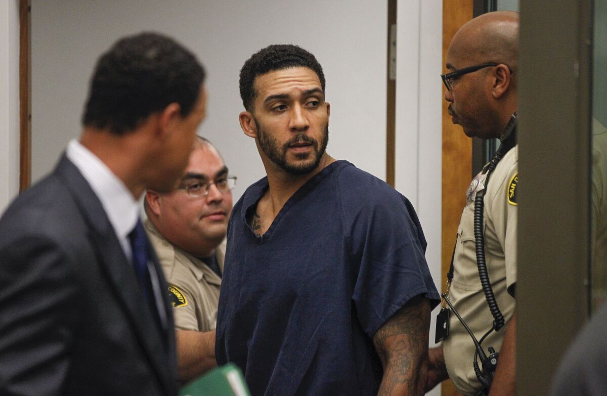 As he is led from the courtroom after his arraignment at the Vista courthouse in June 2018, former NFL player Kellen Winslow II looks toward where his father Kellen Winslow, also a former NFL player, is sitting in the gallery.