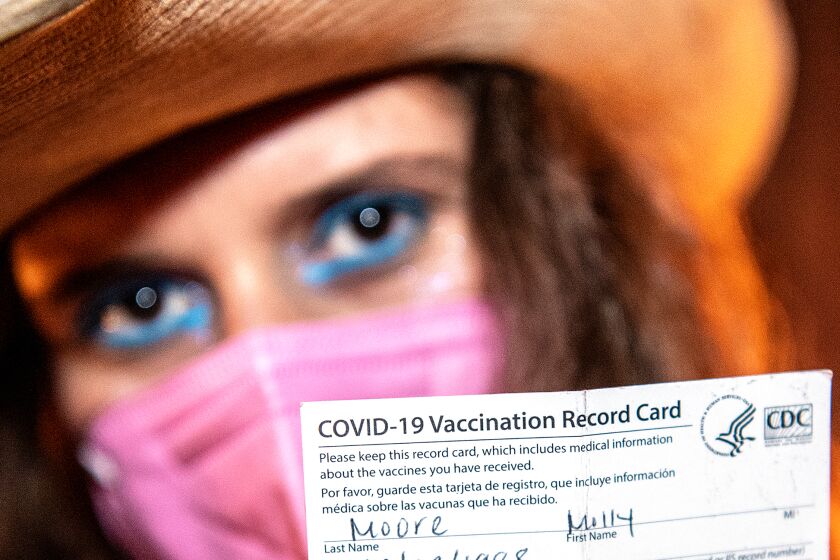 Molly Moore shows off her vaccine card which allowed her to gain entry into Permanent Records Roadhouse 