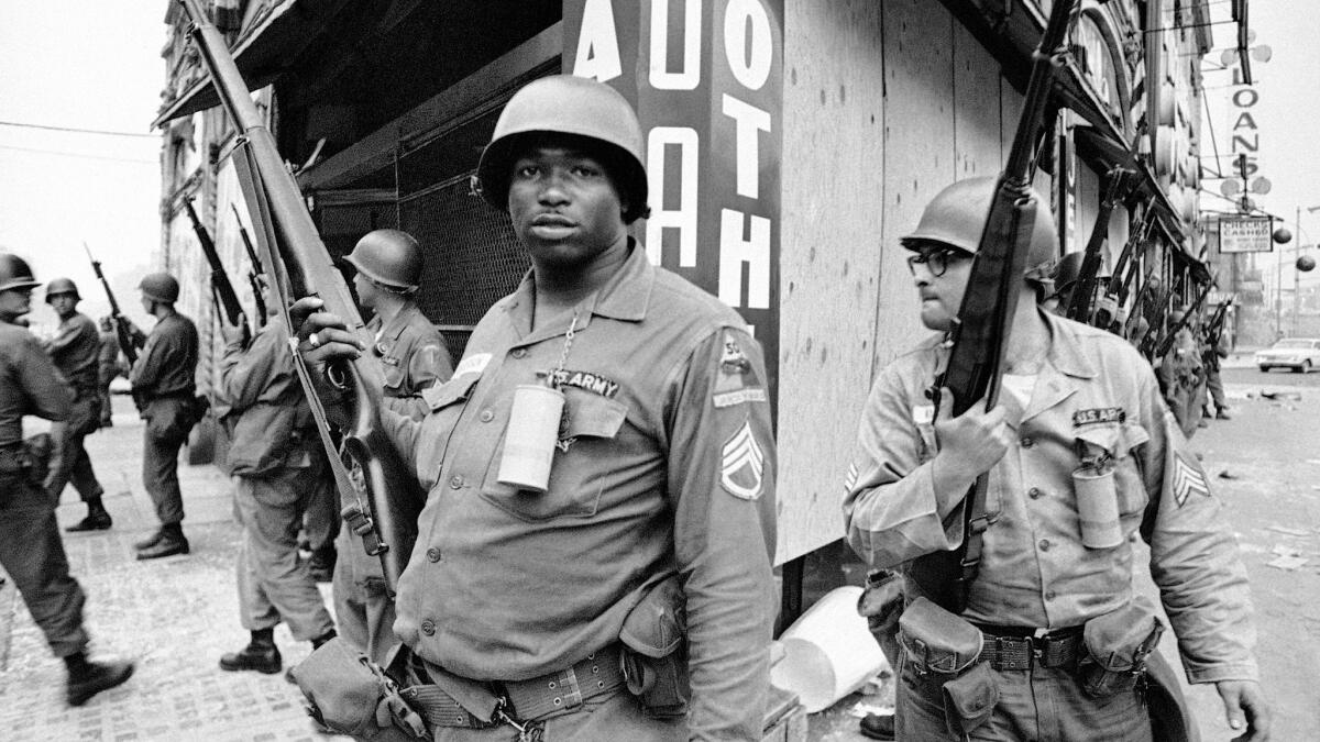 National Guardsmen stand at the corner of Springfield Avenue and Mercer Street in Newark, N.J., where four days of deadly violence and looting in 1967 came to be known as the Newark riots.