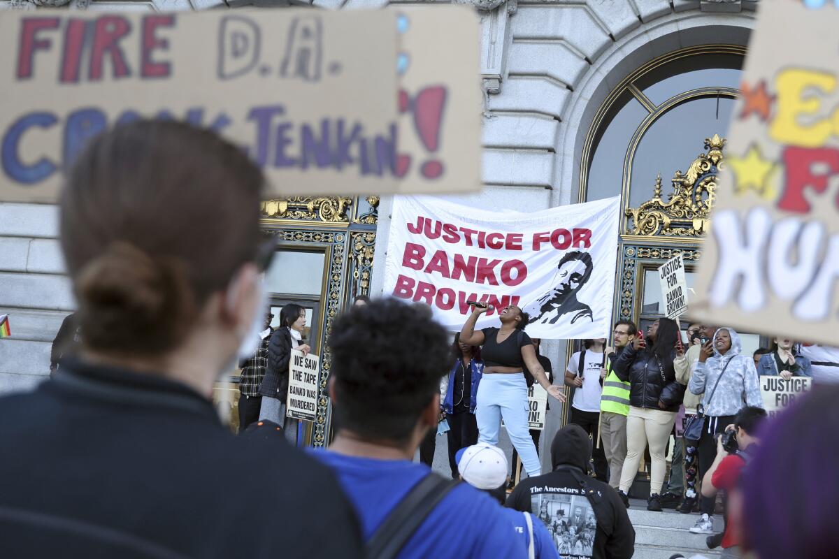 Demonstrators hold a banner reading "Justice for Banko Brown!"