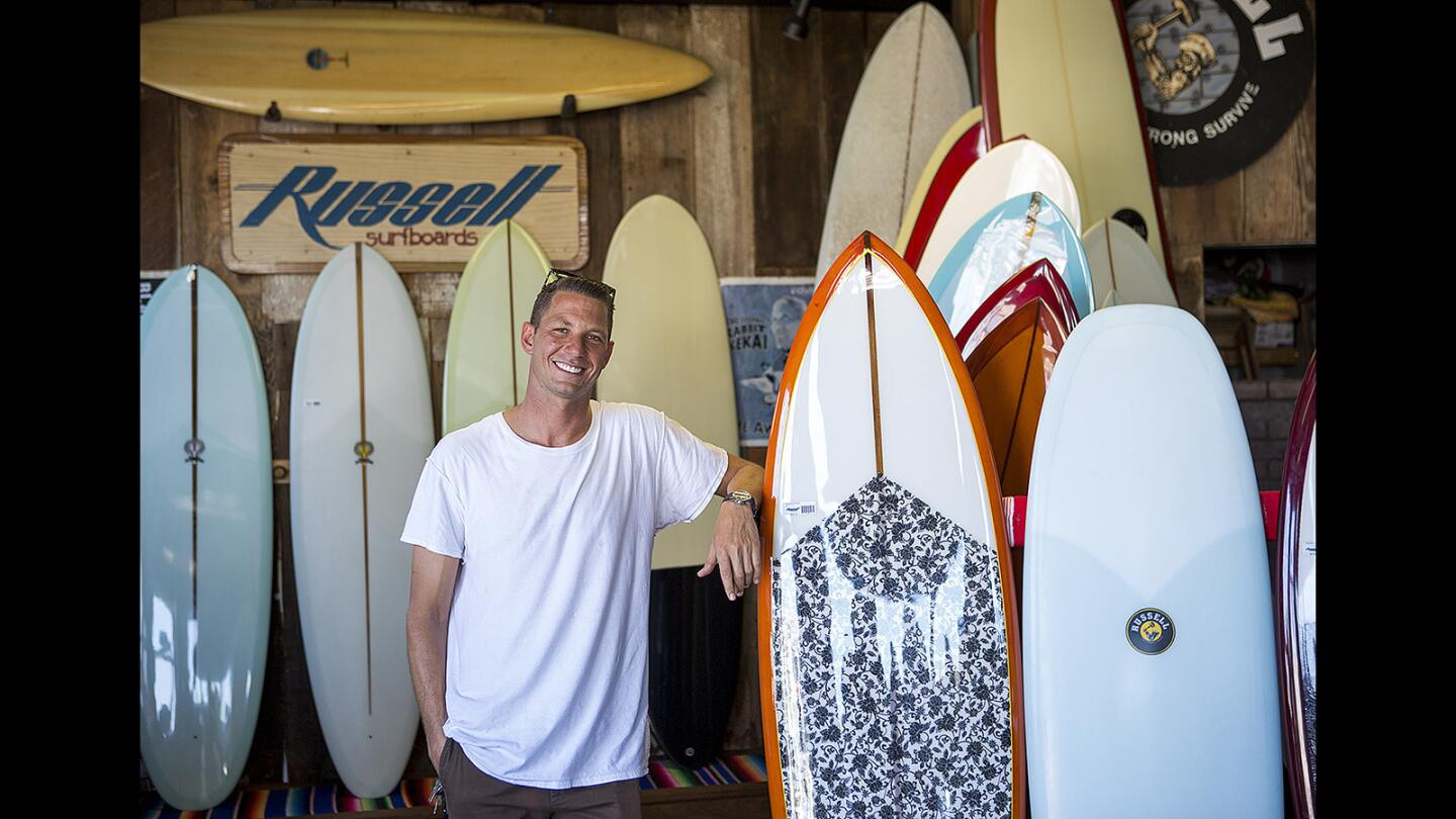 J.P. Roberts is the owner of Russell Surfboards. The shop is celebrating 50 years of business.