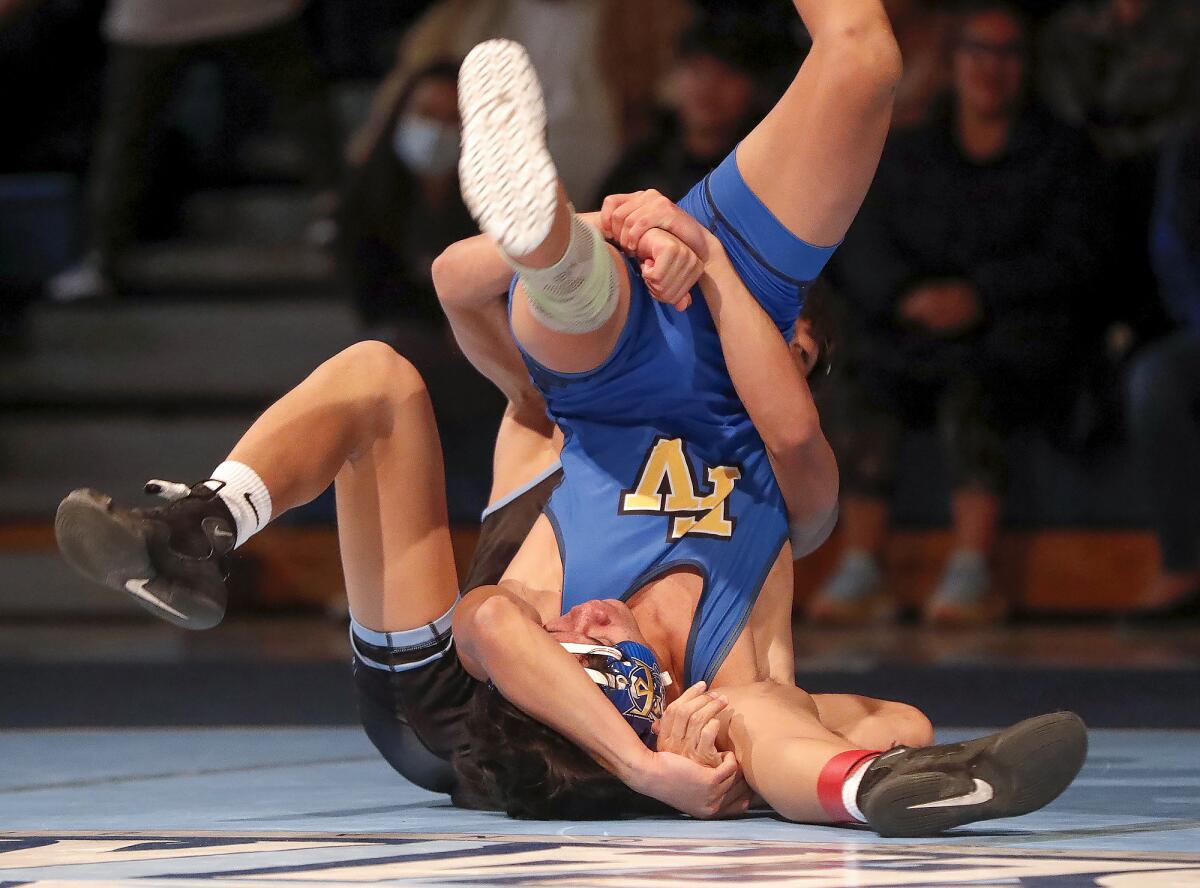 Fountain Valley's Mathew Phillips gets tangled up with Corona del Mar's Angelo Gonzalez.