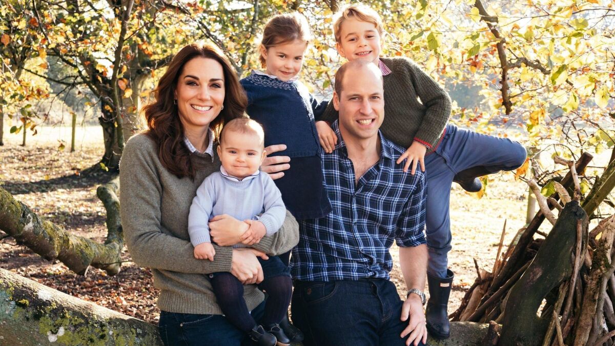 Catherine, Duchess of Cambridge, and husband Prince William pose for a photo with their three children, Prince Louis, Princess Charlotte and Prince George.