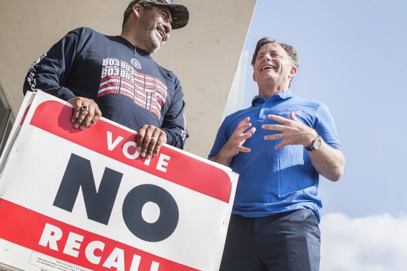 Rich Gomez of Orange County Southwest Regional Council of Carpenters, left, chats with state Sen. Josh Newman before knocking on doors in the district to urge voters to vote no on a recall of Newman in Fullerton on Saturday, April 28, 2018. (Nick Agro / For The Times)