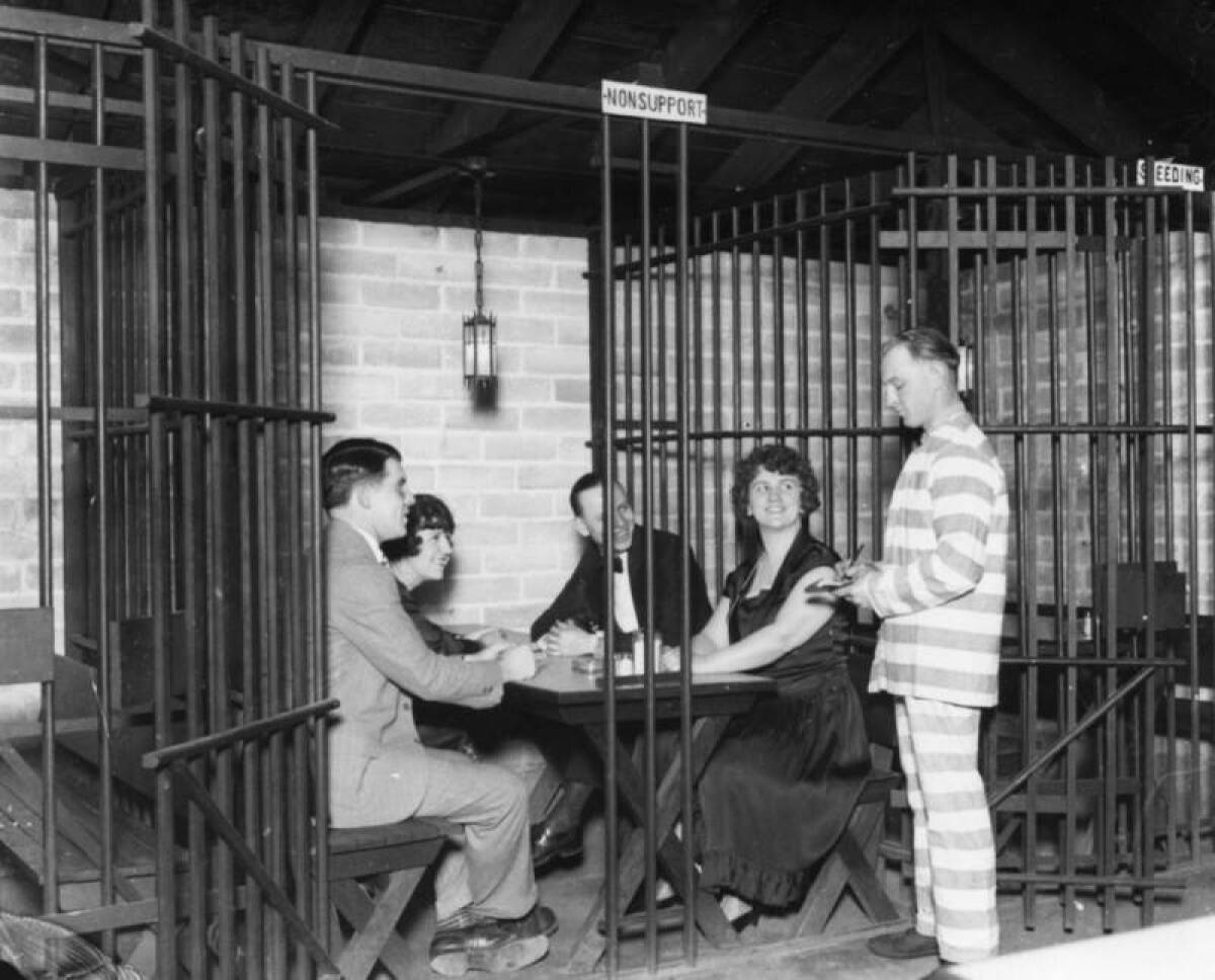 Two couples give their order to a "convict" waiter at the Jail Cafe, which opened in 1925 on 4212 Sunset Blvd.