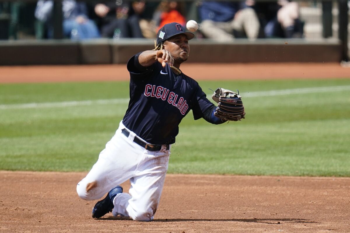 Cleveland Guardians third baseman Jose Ramirez throws from his knees to second base but is unable to get the force out on an infield single by Milwaukee Brewers' Pedro Severino during the third inning of a spring training baseball game Tuesday, March 29, 2022, in Goodyear, Ariz. (AP Photo/Ross D. Franklin)