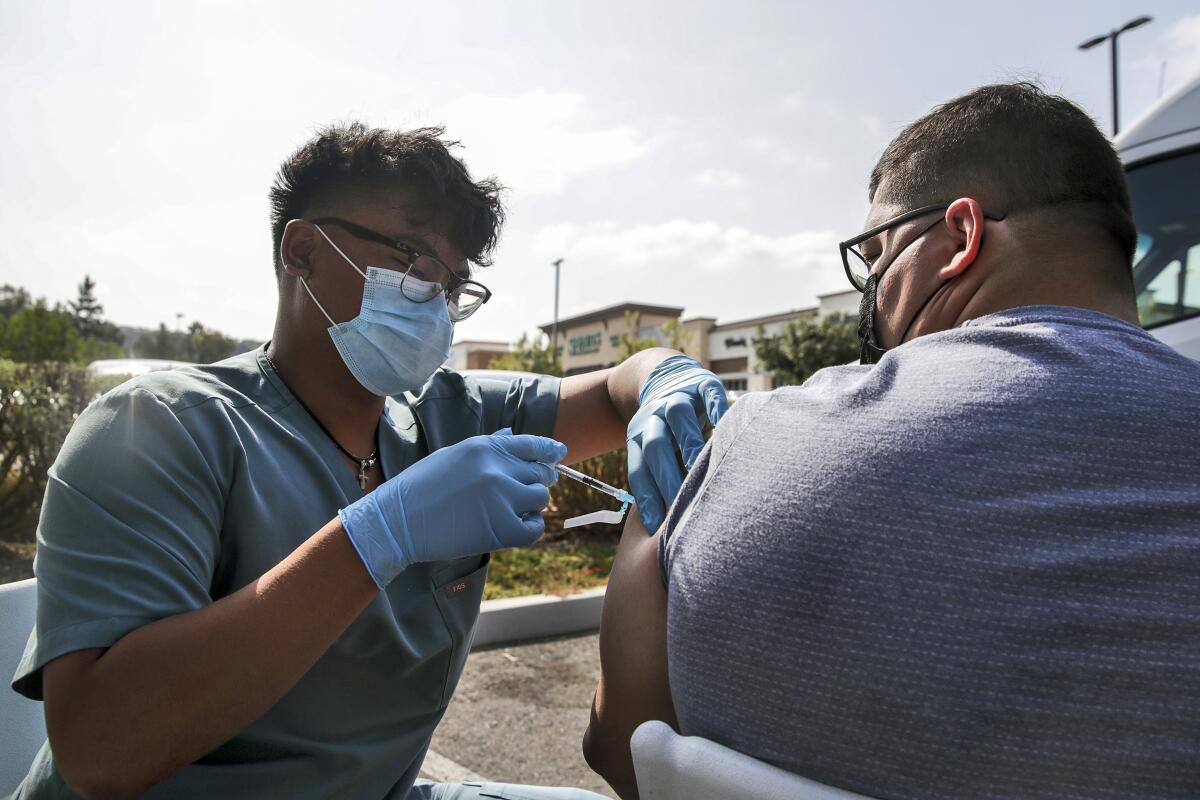 A man receives a COVID-19 vaccine