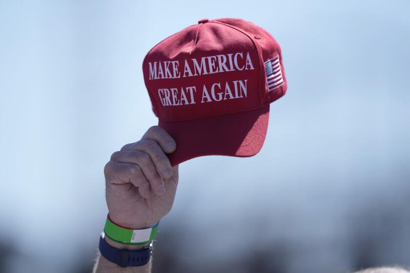 FILE - An attendee waves a hat ahead of a campaign rally for Republican presidential candidate former President Donald Trump in Wildwood, N.J., on May 11, 2024. Trump's presidential campaign will begin accepting donations in cryptocurrency, the presumptive Republican presidential nominee's campaign says. (AP Photo/Matt Rourke)