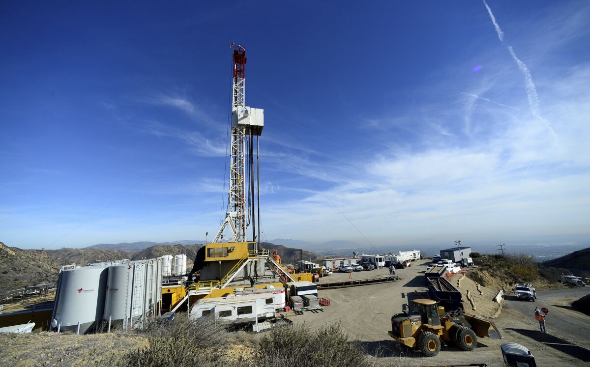 FILE - Crews from SoCalGas and outside experts work on a relief well to be connected to a leaking well at the Aliso Canyon facility above the Porter Ranch area of Los Angeles, on Dec. 9. 2015. Los Angeles County public health officials are seeking independent researchers to study the short- and long-term effects of the nation's largest known natural gas leak on the health of people who lived in nearby communities. The county Department of Public Health announced the request for proposals in a statement Tuesday, Jan. 18, 2022. (Dean Musgrove/Los Angeles Daily News via AP, Pool, File)