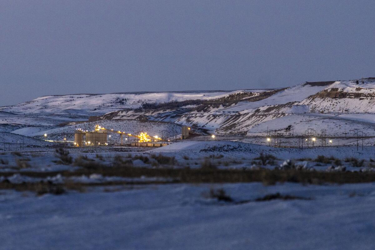 Lights illuminate a coal mine at twilight in Kemmerer, Wyo.