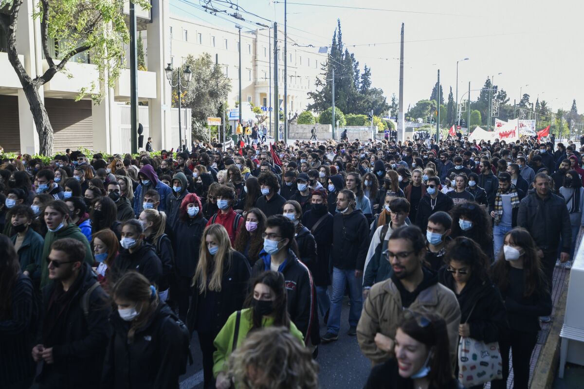 Protesters march during a rally in Athens, Greece, on Monday Dec. 6, 2021. Hundreds of protesters marched the streets of the Greek capital, on the 13th anniversary of the 15-year old Alexis Grigoropoulos' fatal shooting by the police. (AP Photo/Michael Varaklas)