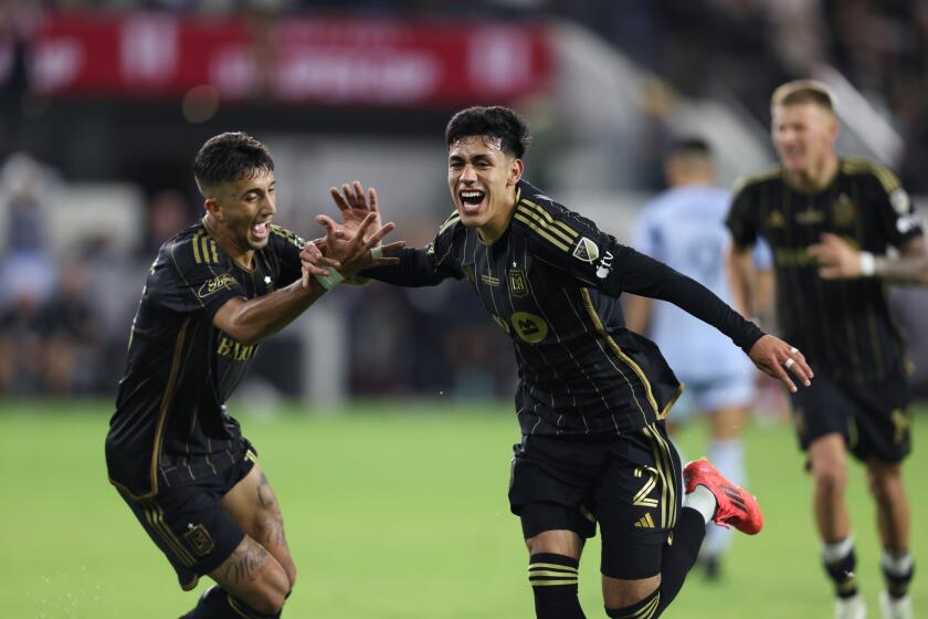 LAFC's Omar Campos celebrates with Sergi Palencia after scoring a goal against Sporting Kansas City during extra time