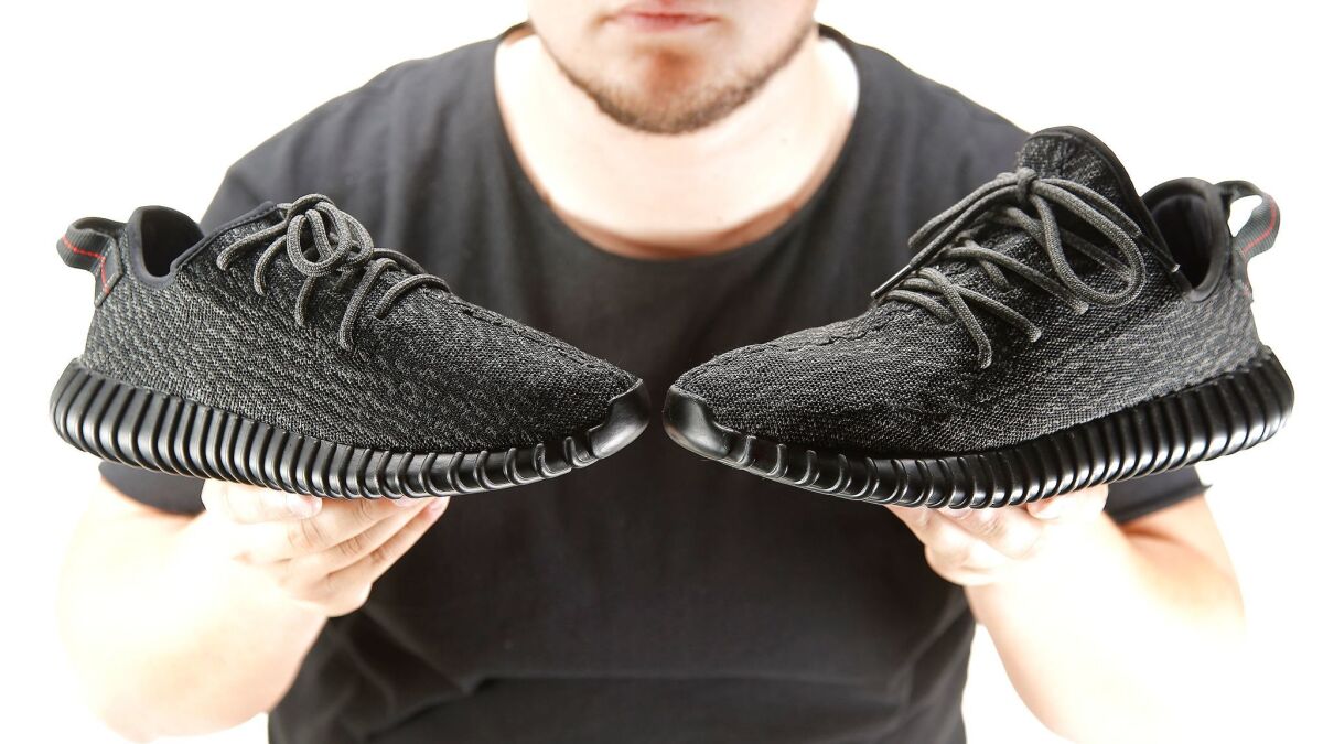 An authentic Yeezy, left, and a replica model owned by Kevin, right. (Kirk McKoy / Los Angeles Times)