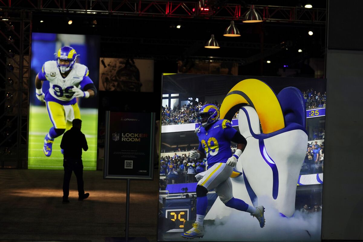 Images of Los Angeles Rams defensive end Aaron Donald are displayed inside the NFL Experience, an interactive fan show, Friday, Feb. 4, 2022, at the Los Angeles Convention Center in Los Angeles. The Rams are scheduled to play the Cincinnati Bengals in the Super Bowl NFL football game Feb. 13 in Inglewood, Calif. (AP Photo/Marcio Jose Sanchez)