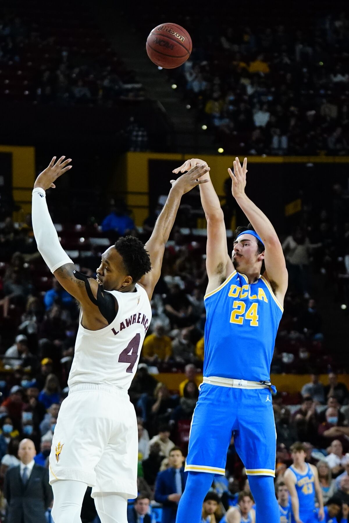 The Bruins' Jaime Jaquez Jr. attempts a three-pointer over Arizona State's Kimani Lawrence in the first half Feb. 5, 2022.