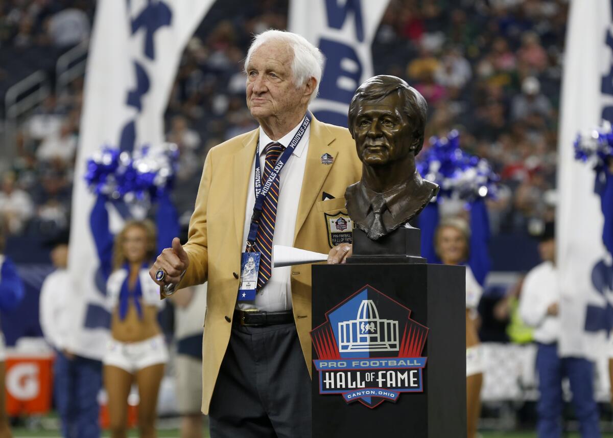 Gil Brandt poses with his Pro Football Hall of Fame bust.