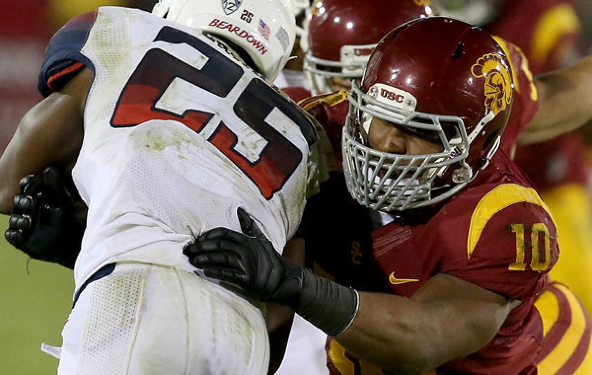 USC linebacker Hayes Pullard takes down Arizona running back Ka'Deem Carey during a win in October. Pullard has learned plenty of lessons from his coaches and teammates over the years.