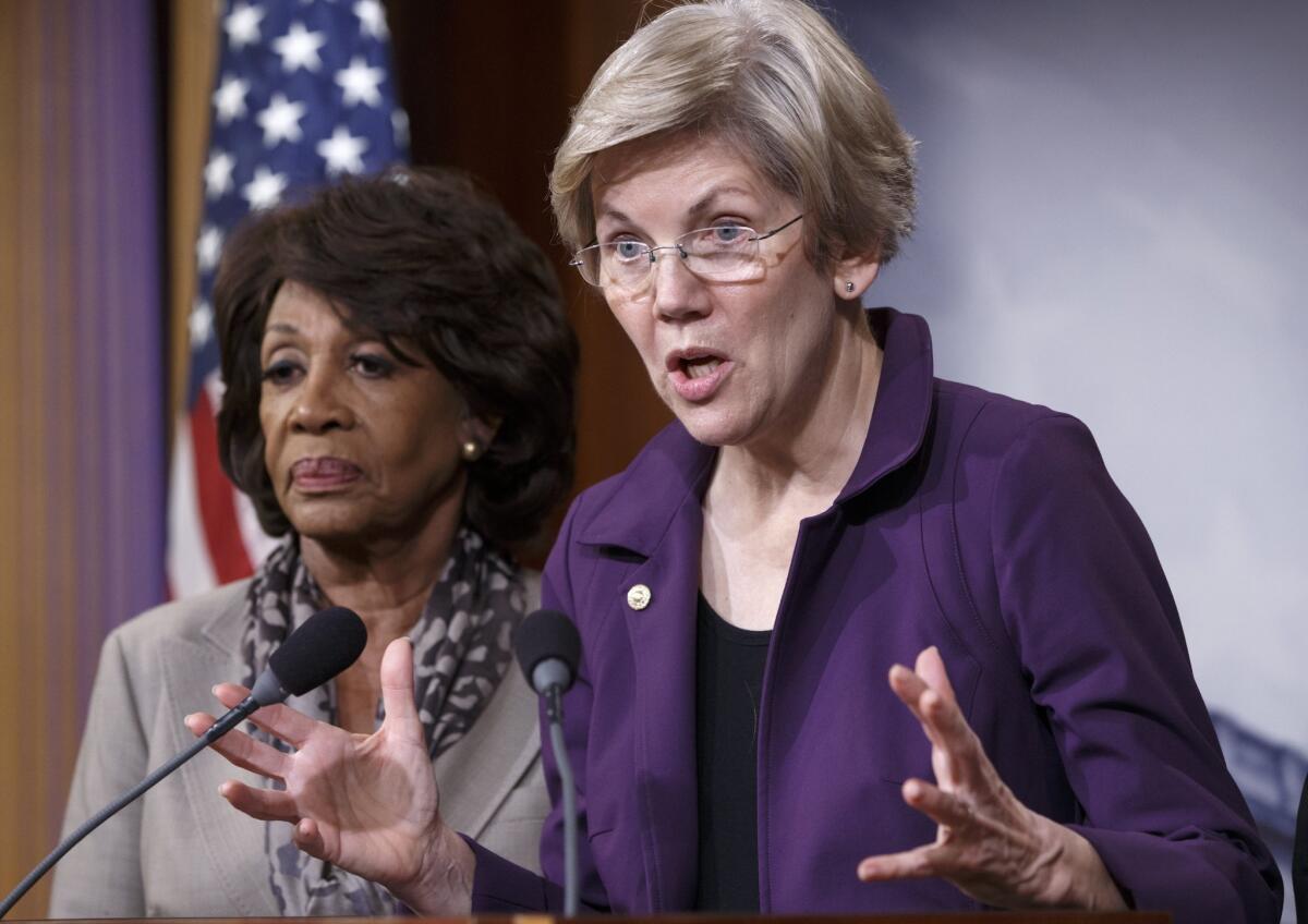 Sen. Elizabeth Warren (D-Mass.), front, and Rep. Maxine Waters (D-Calif.)voice their objections to a House-approved spending bill that includes a repeal of the Dodd-Frank divide between traditional banks and derivative trading, during a news conference at the Capitol in Washington.