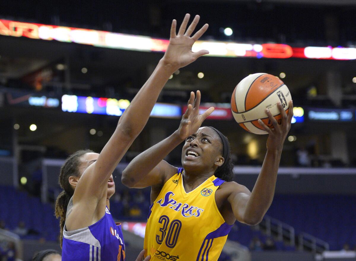 Sparks forward Nneka Ogwumike puts up a shot as Mercury center Brittney Griner defends during the first half of a Western Conference playoff game on Sept. 23, 2013.