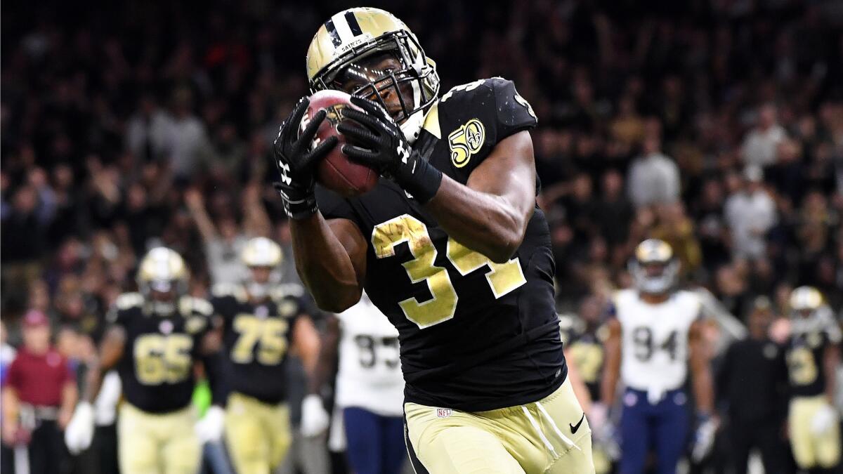 Saints running back Tim Hightower catches a 50-yard touchdown pass from wide receiver Willie Snead in the fourth quarter Sunday.