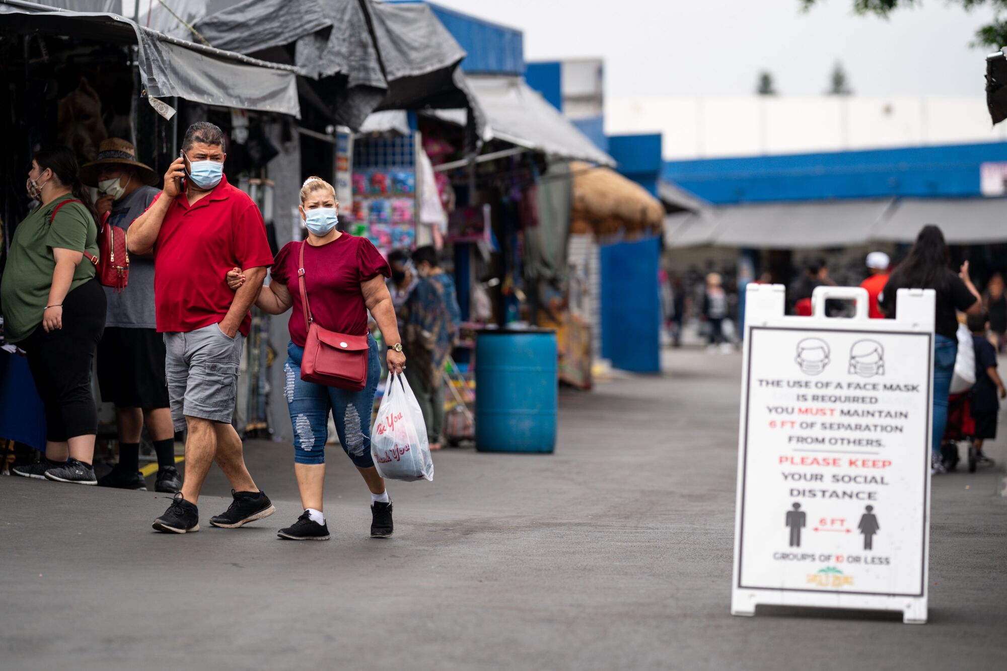 People going to the Santa Fe Springs Swap Meet are required to wear masks and maintain proper social distancing