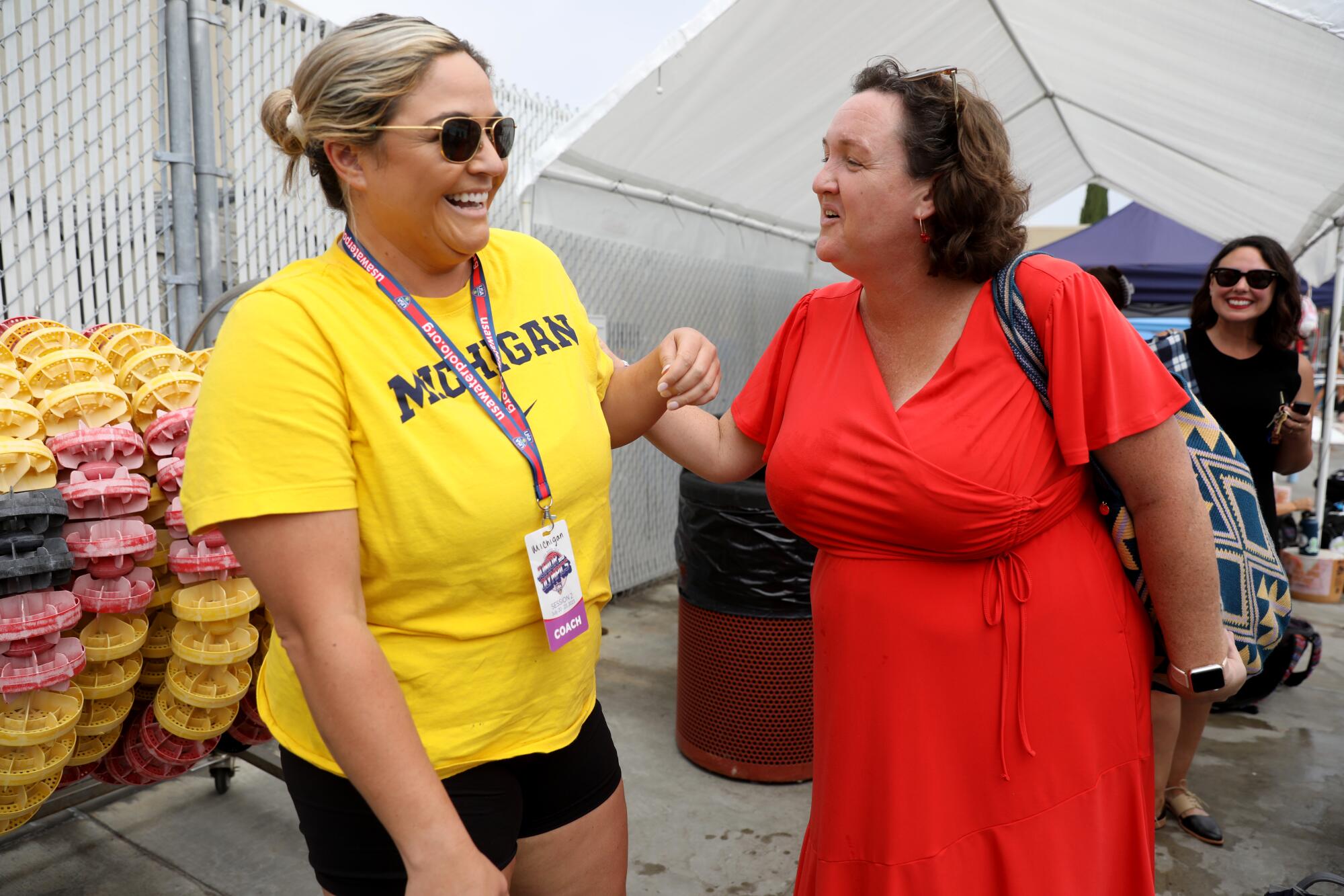Katie Porter speaking with a woman wearing a shirt that reads, "Michigan"