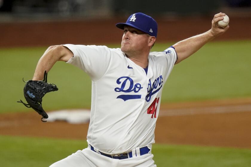 Los Angeles Dodgers relief pitcher Jake McGee throws against the Atlanta Braves during the sixth inning in Game 2 of a baseball National League Championship Series Tuesday, Oct. 13, 2020, in Arlington, Texas. (AP Photo/Eric Gay)