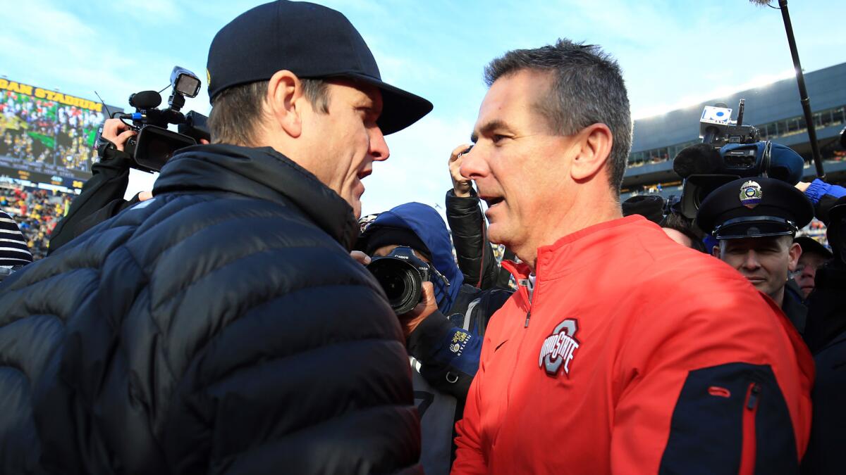 Michigan's Jim Harbaugh, left, and Urban Meyer of Ohio State will lead their teams into a critical Big Ten battle on Saturday.