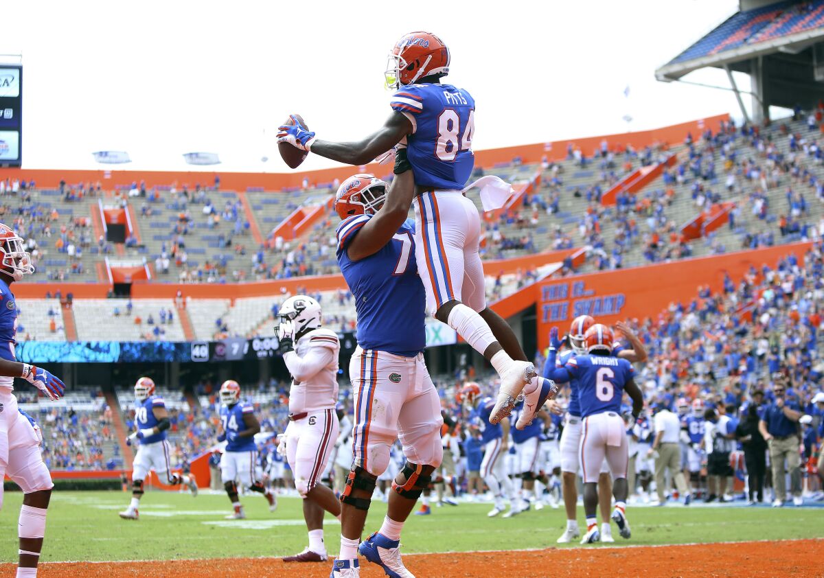 Florida tight end Kyle Pits (84) leaps up as he celebrates a touchdown catch with teammates during an NCAA college football game against South Carolina in Gainesville, Fla., Saturday, Oct. 3, 2020. (Brad McClenny/The Gainesville Sun via AP, Pool)
