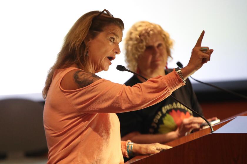Public speaker Bethany Webb addresses the commission against privatizing the Huntington Beach Library.