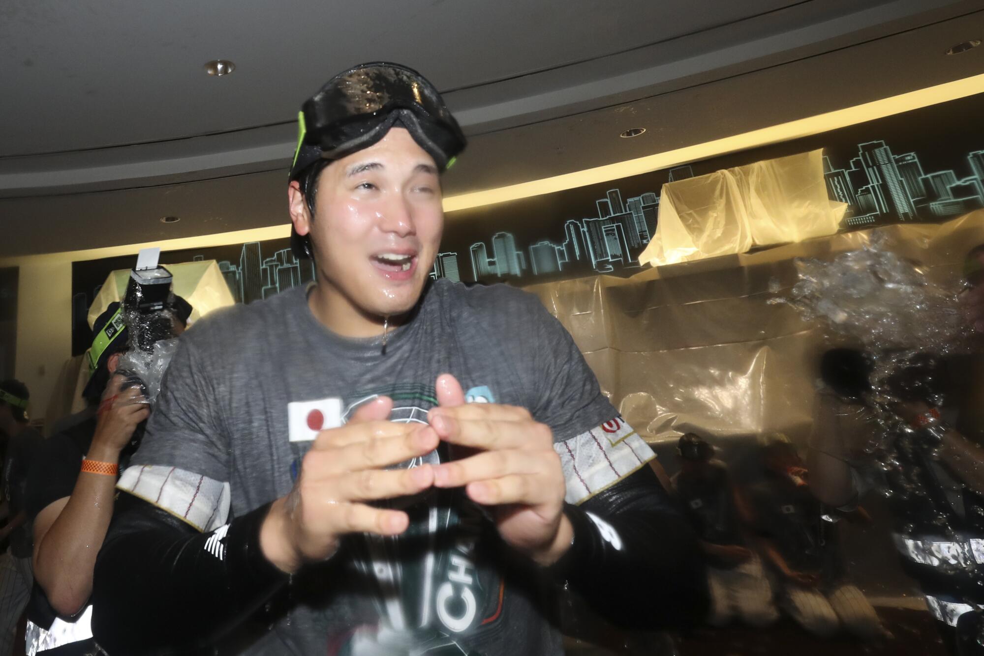 Shohei Ohtani and his teammates spray champagne in the clubhouse after Japan beat the U.S.