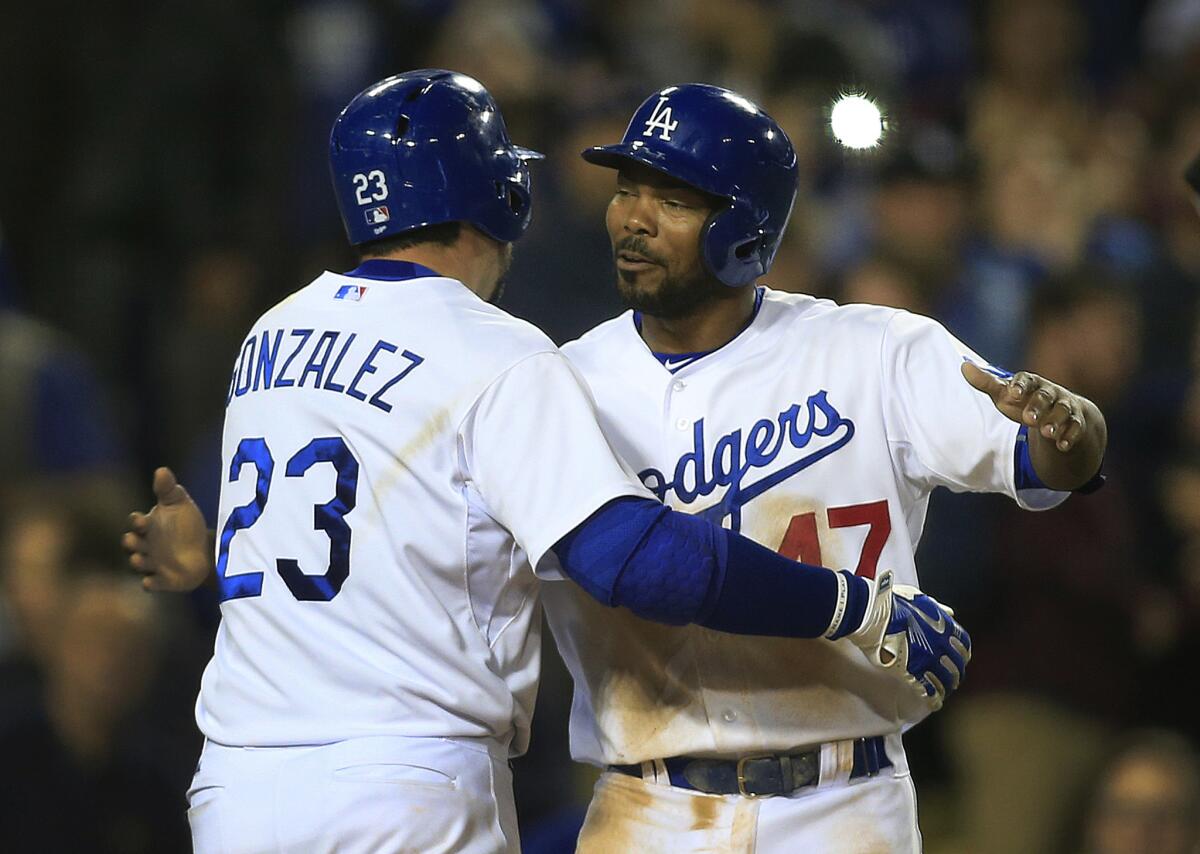 Dodgers second baseman Howie Kendrick congratulates first baseman Adrian Gonzalez after his two-run home run in the fifth inning.