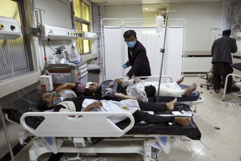 Afghan school students are treated at a hospital after a bomb explosion near a school in west of Kabul, Afghanistan, Saturday, May 8, 2021. A bomb exploded near a school in west Kabul on Saturday, killing several, many them young students, Afghan government spokesmen said. (AP Photo/Rahmat Gul)