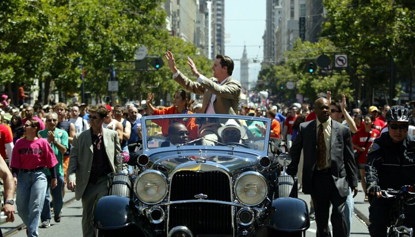 Mayor Gavin Newsom, center, waves to the crowds at the 34th annual Gay Pride Parade down Market Street in San Francisco in 2004.