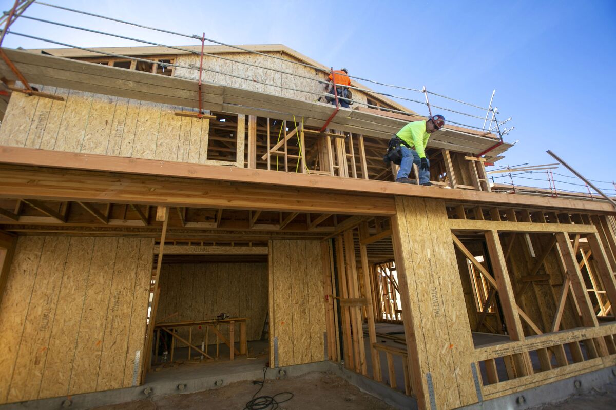 Construction workers install sheathing on a new single family homes under construction in the Seville project in Chula Vista on Friday, January 31, 2020.