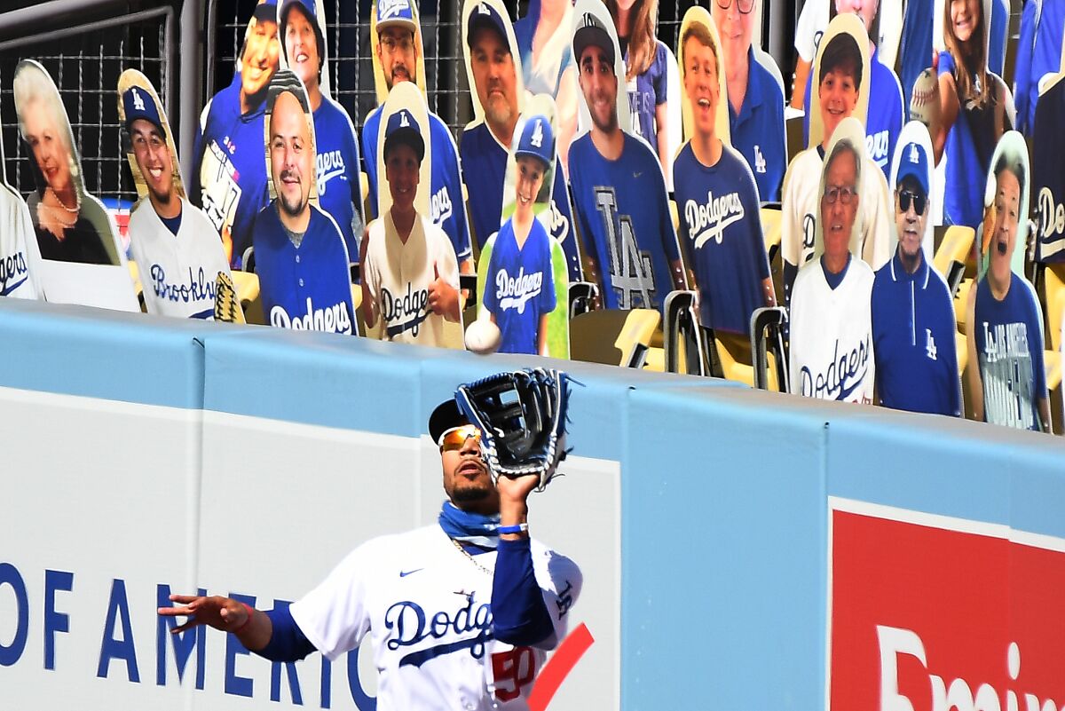 Dodgers right fielder Mookie Betts makes a catch against the Giants to end Sunday's game at Dodger Stadium.
