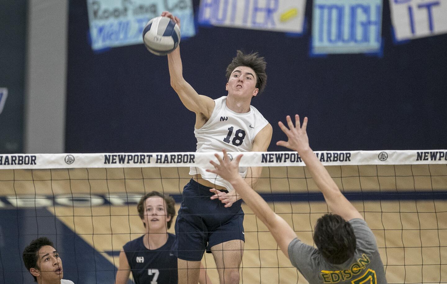 Newport Harbor's Ethan Talley hits against Edison's Trevor McKay during a Sunset League match on Friday, March 30.