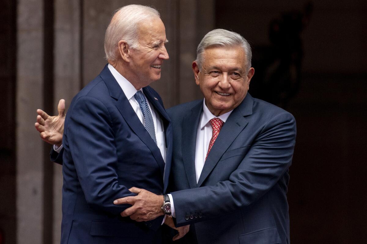 Mexican President Andrés Manuel López Obrador greets President Biden at the National Palace in Mexico City.