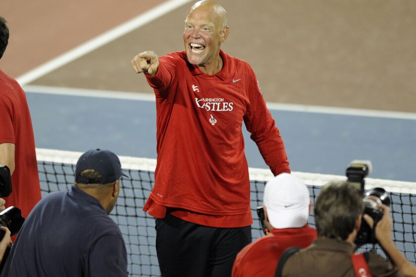 Washington Kastles coach Murphy Jensen celebrates after they beat the Boston Lobsters for their 34th straight win in a World Team Tennis match, Tuesday, July 9, 2013, in Washington. (AP Photo/Nick Wass)