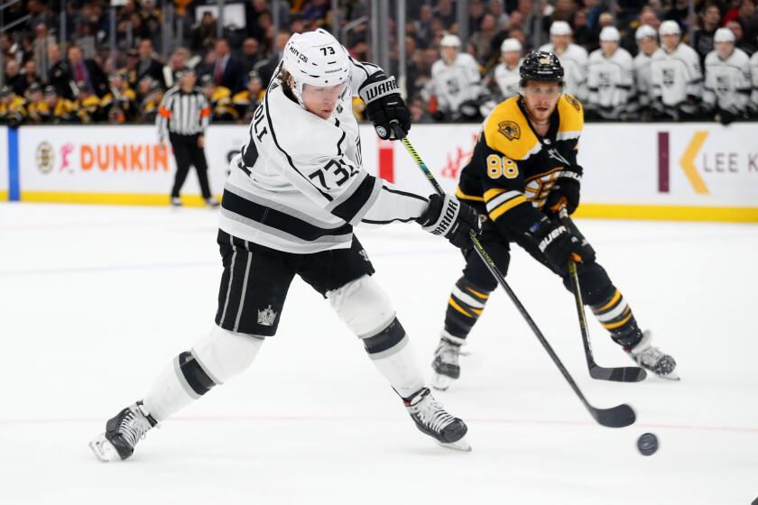 BOSTON, MASSACHUSETTS - DECEMBER 17: David Pastrnak #88 of the Boston Bruins defends Tyler Toffoli #73 of the Los Angeles Kings to defeat the Boston Bruins 4-3 in overtime at TD Garden on December 17, 2019 in Boston, Massachusetts. (Photo by Maddie Meyer/Getty Images)